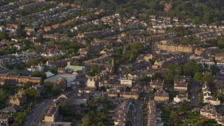 AX112_002E - 5.5K aerial stock footage of Saint Ninian's Church and residential neighborhood, Edinburgh, Scotland at sunset