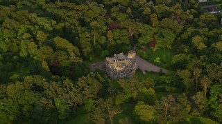 AX112_005 - 5.5K aerial stock footage of orbiting Hillwood House and trees, Edinburgh, Scotland at sunset