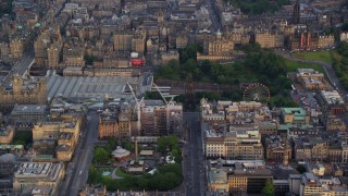 AX112_013E - 5.5K aerial stock footage of St Andrew Square and shopping mall, Edinburgh, Scotland at sunset