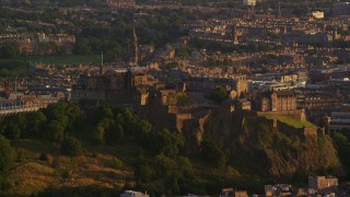 AX112_040E - 5.5K aerial stock footage of a view of Edinburgh Castle in Scotland at sunset