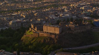 AX112_051 - 5.5K aerial stock footage video of orbiting Edinburgh Castle, Scotland at sunset