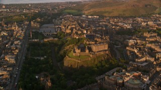 AX112_053 - 5.5K aerial stock footage flyby historic Edinburgh Castle and surrounding cityscape, Scotland at sunset
