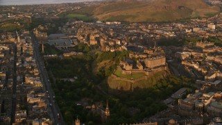 AX112_054 - 5.5K aerial stock footage of historic Edinburgh Castle and cityscape, Scotland at sunset