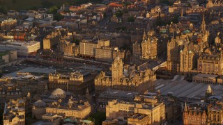 AX112_057E - 5.5K aerial stock footage of flying by Balmoral Hotel and North Bridge, Edinburgh, Scotland at sunset