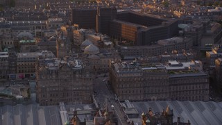 AX112_086 - 5.5K aerial stock footage of the Balmoral Hotel and National Archives, Edinburgh Scotland Sunset