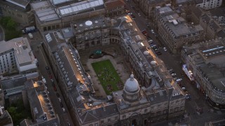 AX112_106 - 5.5K aerial stock footage of orbiting University of Edinburgh School of Law, Scotland  at sunset