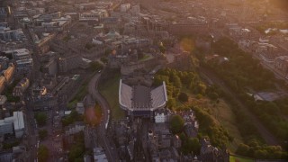 AX112_107E - 5.5K aerial stock footage approach and fly over Edinburgh Castle, Scotland at sunset