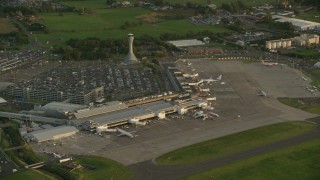 AX112_119 - 5.5K aerial stock footage of orbiting Edinburgh Airport, Scotland at sunset