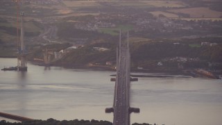 AX112_122E - 5.5K aerial stock footage of the Forth Road Bridge over the Firth of Forth, Edinburgh, Scotland at sunset
