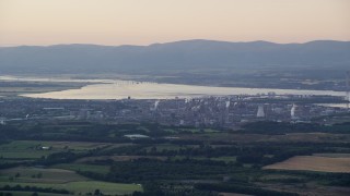 AX112_140E - 5.5K aerial stock footage of a natural gas power plant beside the water, Falkirk, Scotland at sunset