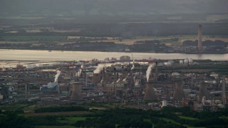 AX112_142 - 5.5K aerial stock footage of a natural gas plant by water, Falkirk, Scotland at twilight