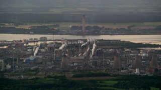 AX112_143 - 5.5K aerial stock footage of a natural gas plant overlooking the water, Falkirk, Scotland at twilight