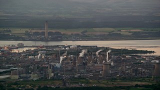 AX112_144 - 5.5K aerial stock footage flyby natural gas plant by the water, Falkirk, Scotland at twilight