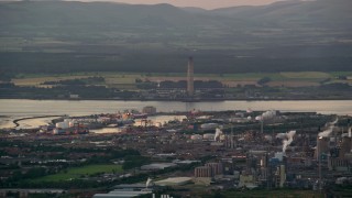 AX112_145 - 5.5K aerial stock footage flyby natural gas plant by the water, Falkirk, Scotland at twilight