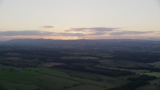 AX112_149 - 5.5K aerial stock footage of farms and transmitting station, Falkirk, Scotland at sunset