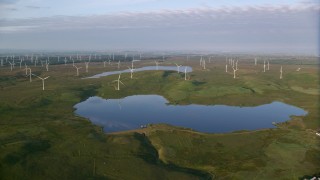 AX113_010 - 5.5K aerial stock footage of windmills and reservoirs, Eaglesham, Scotland at sunrise