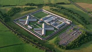 AX113_032 - 5.5K aerial stock footage of orbiting Kilmarnock Prison, Scotland at sunrise