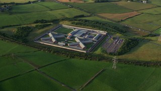 AX113_032E - 5.5K aerial stock footage of orbiting Kilmarnock Prison in Scotland at sunrise