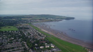 AX113_039E - 5.5K aerial stock footage fly over beachfront homes near Firth of Clyde in Ayr, Scotland