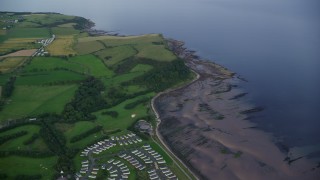 AX113_043E - 5.5K aerial stock footage of farms and fields on the coast of the Firth of Clyde, Ayr, Scotland