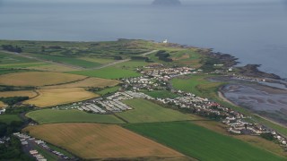AX113_057E - 5.5K aerial stock footage flyby coastal village and Turnberry Golf Course along Firth of Clyde, Maidens, Scotland
