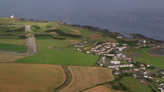 AX113_059 - 5.5K aerial stock footage flyby coastal village and Turnberry Golf Course along Firth of Clyde, Maidens, Scotland