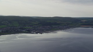 AX113_070E - 5.5K aerial stock footage of the coastal town of Girvan seen from Firth of Clyde, Scotland