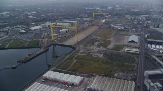 AX113_081E - 5.5K aerial stock footage orbit construction cranes at the Port of Belfast, Northern Ireland
