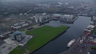 AX113_085 - 5.5K aerial stock footage of Odyssey Arena and Titanic Museum on the River Lagan, Belfast, Northern Ireland
