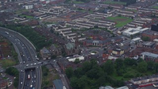 AX113_109E - 5.5K aerial stock footage of orbiting the Carlisle Circus roundabout by a church in Belfast, Northern Ireland