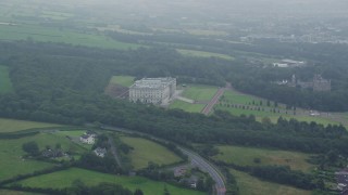 AX113_123E - 5.5K aerial stock footage video of Parliament Buildings, grounds and trees, Belfast, Northern Ireland