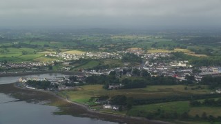 AX113_151 - 5.5K aerial stock footage flyby a village and farmland along Strangford Lough, Killyleagh, Northern Ireland