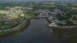 AX113_153 - 5.5K aerial stock footage orbiting a waterfront village and fields, Strangford Lough, Killyleagh, Northern Ireland