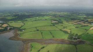 AX113_154E - 5.5K aerial stock footage orbiting farms and farm fields, Killyleagh, Northern Ireland