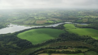 AX113_160 - 5.5K stock footage aerial video of farmland along the Quoile River, Downpatrick, Northern Ireland