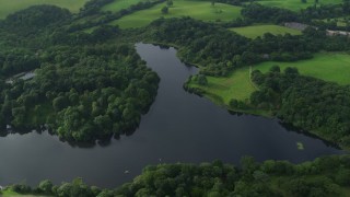 AX113_161 - 5.5K aerial stock footage of trees and farmland along the Quoile River, Downpatrick, Northern Ireland