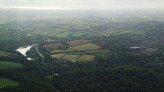 AX113_164E - 5.5K aerial stock footage of farm fields and trees around the Quoile River, Downpatrick, Northern Ireland
