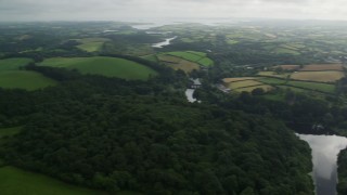 AX113_167 - 5.5K aerial stock footage of fields and trees by the Quoile River, Downpatrick, Northern Ireland