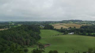 AX113_168 - 5.5K aerial stock footage of trees and farmland, Downpatrick, Northern Ireland