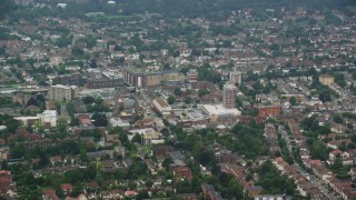 AX114_005E - 5.5K aerial stock footage of apartment buildings and shopping center, Wallington, England