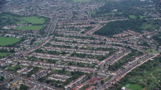 AX114_013E - 5.5K aerial stock footage of passing by residential neighborhoods, Thornton Heath, England