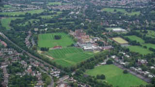 AX114_016E - 5.5K aerial stock footage tilt to a bird's eye view of Dulwich College, London, England