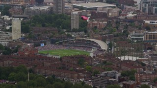 AX114_020 - 5.5K aerial stock footage of a cricket game at The Oval and a blimp, London, England