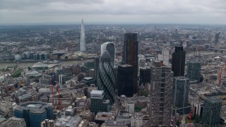 AX114_030E - 5.5K aerial stock footage of River Thames between skyscrapers and The Shard, Central London, England