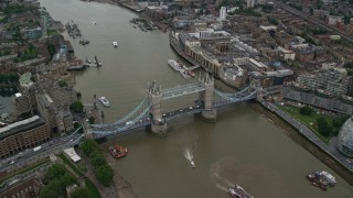 AX114_050 - 5.5K stock footage aerial video approach Tower Bridge over River Thames as cars cross the span, London, England
