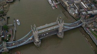 AX114_051 - 5.5K stock footage aerial video tilt to a bird's eye view of the Tower Bridge over River Thames, London, England
