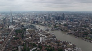 AX114_056E - 5.5K aerial stock footage of Tower Bridge and Tower of London near skyscrapers in Central London, England
