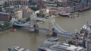 AX114_080E - 5.5K aerial stock footage of light traffic on Tower Bridge spanning the River Thames, London, England