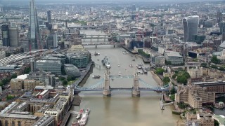 AX114_093 - 5.5K stock footage aerial video orbit the Tower Bridge on River Thames, reveal skyscrapers in Central London, England