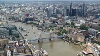 AX114_094 - 5.5K aerial stock footage orbit the Tower Bridge on River Thames near skyscrapers, Central London, England